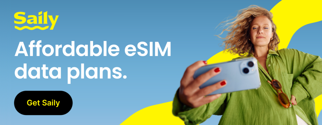 Wide Saily banner ad for affordable eSIM data plans, featuring a traveler taking a selfie with bold yellow branding accents."