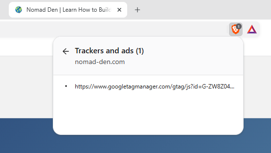 Brave Shields panel listing one blocked tracker on nomad-den.com: the Google tag script that loads Google Analytics